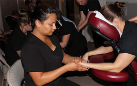 Female learning chair massage in Abilene Texas