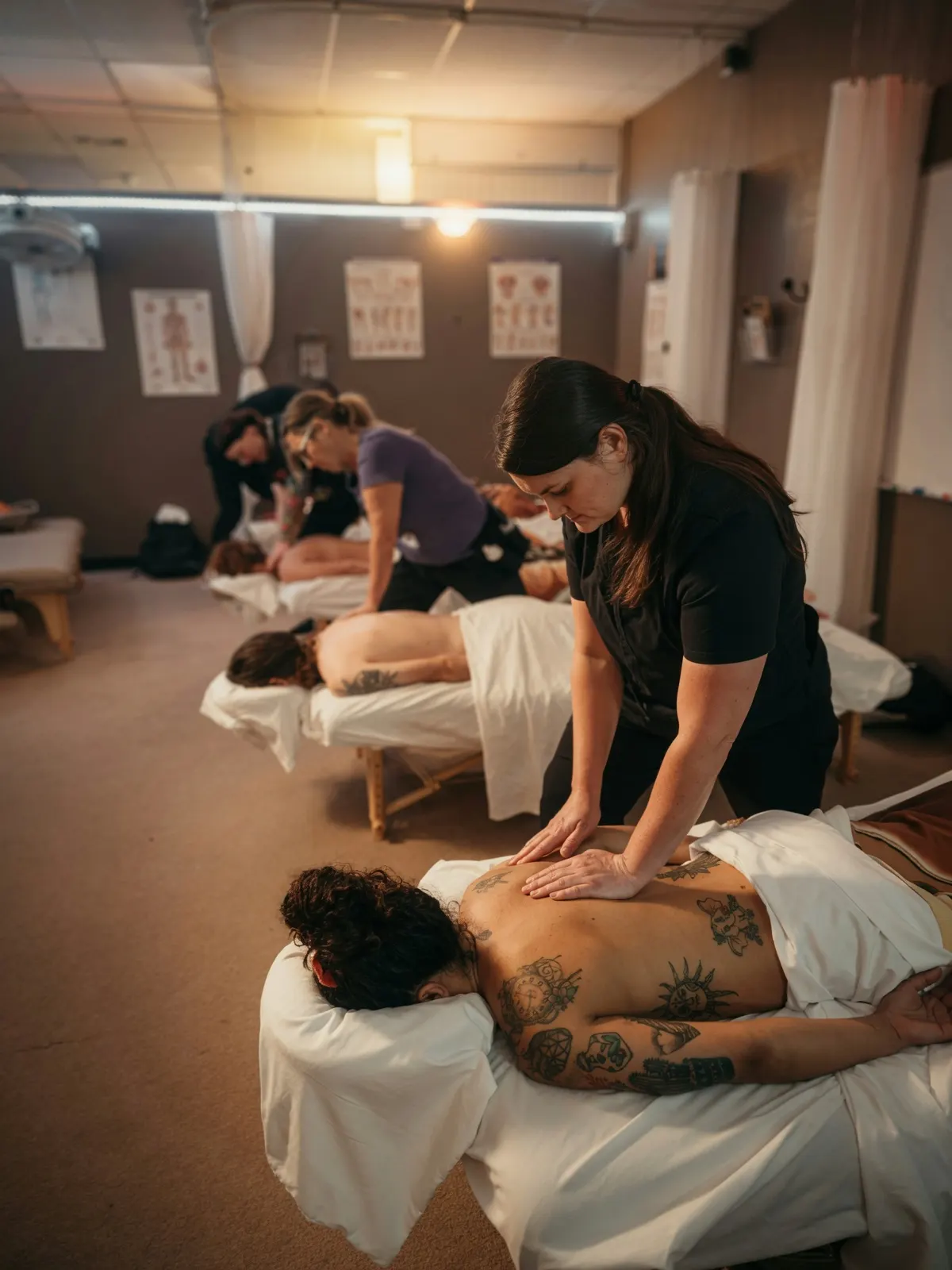 Female student giving back massage in clinic row — Texas Massage Academy, Brownwood TX