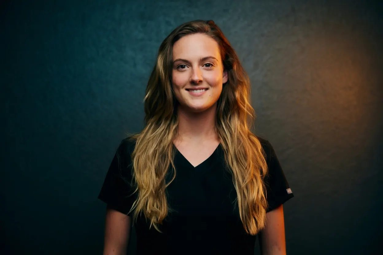 Smiling instructor Kristen portrait in black scrubs — Texas Massage Academy, Brownwood TX