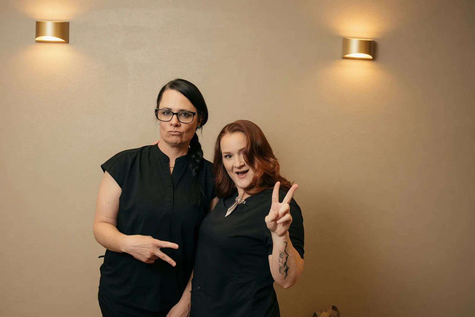 Two massage therapists having fun posing with peace signs — Texas Massage Academy, Brownwood TX