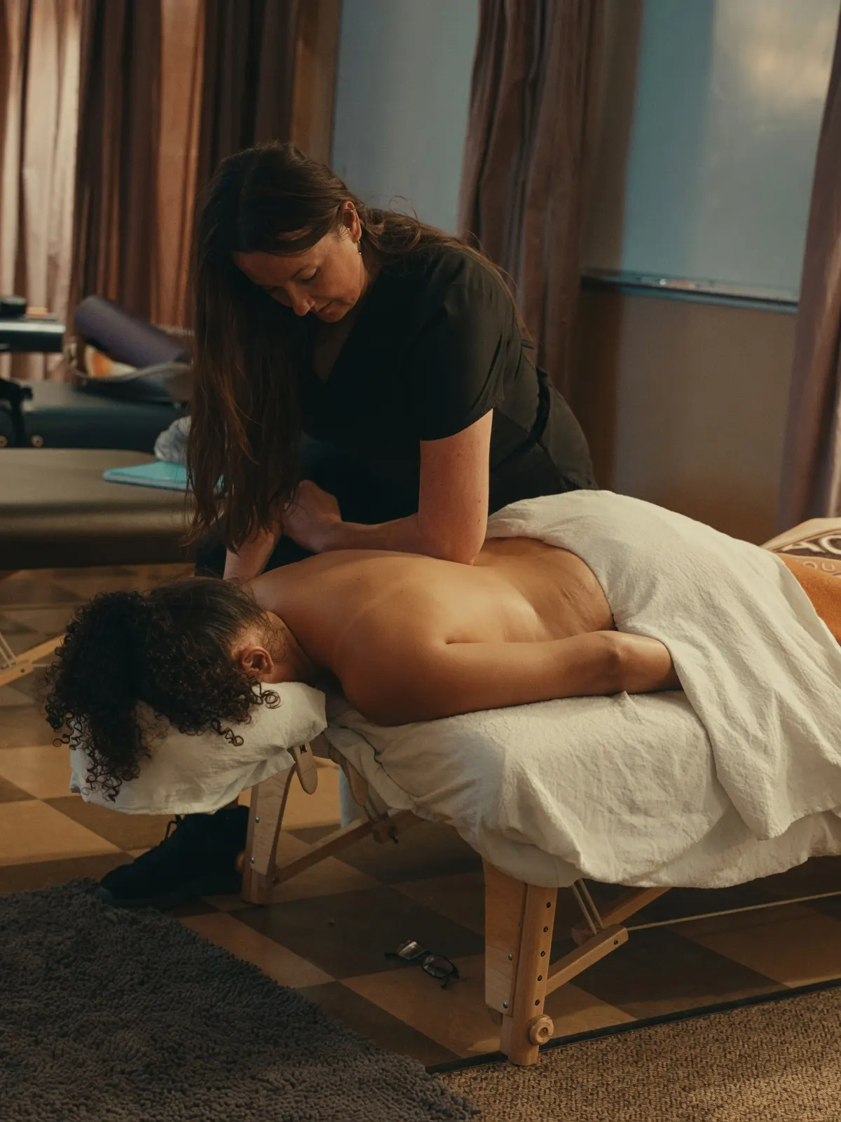 Therapist giving relaxing upper back massage to woman — Texas Massage Academy, Brownwood TX
