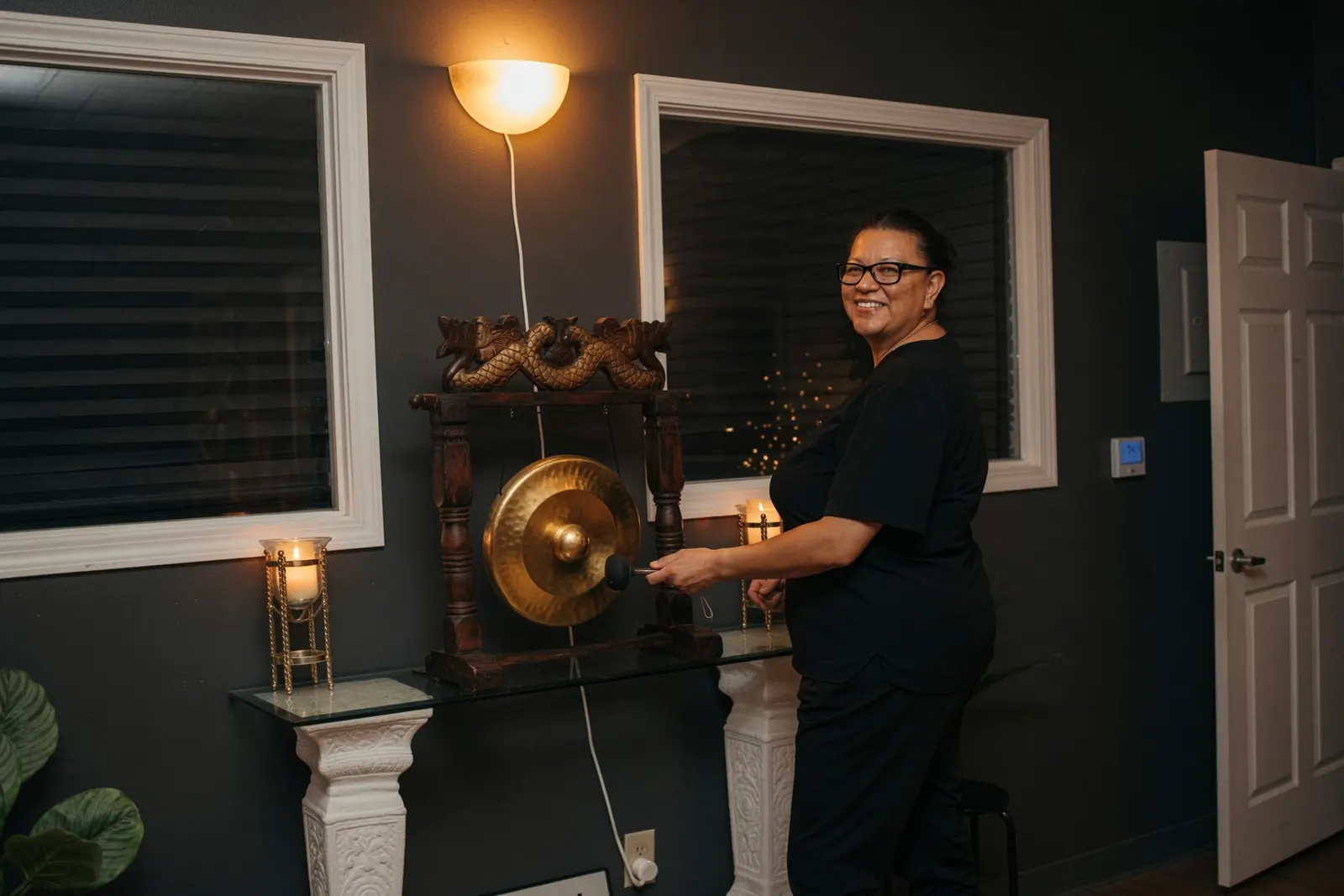 Smiling graduate ringing the gong at the academy — Texas Massage Academy, Brownwood TX