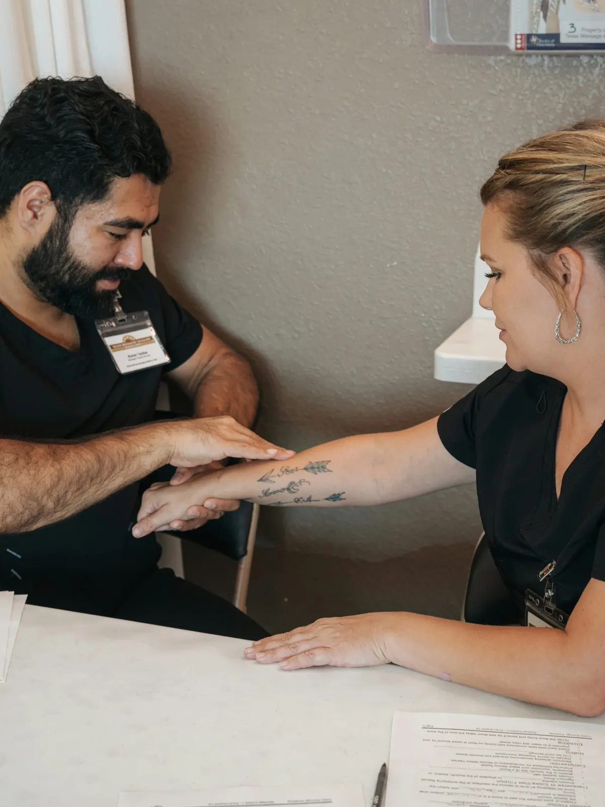 Male and female students practicing arm palpation — Texas Massage Academy, Brownwood TX