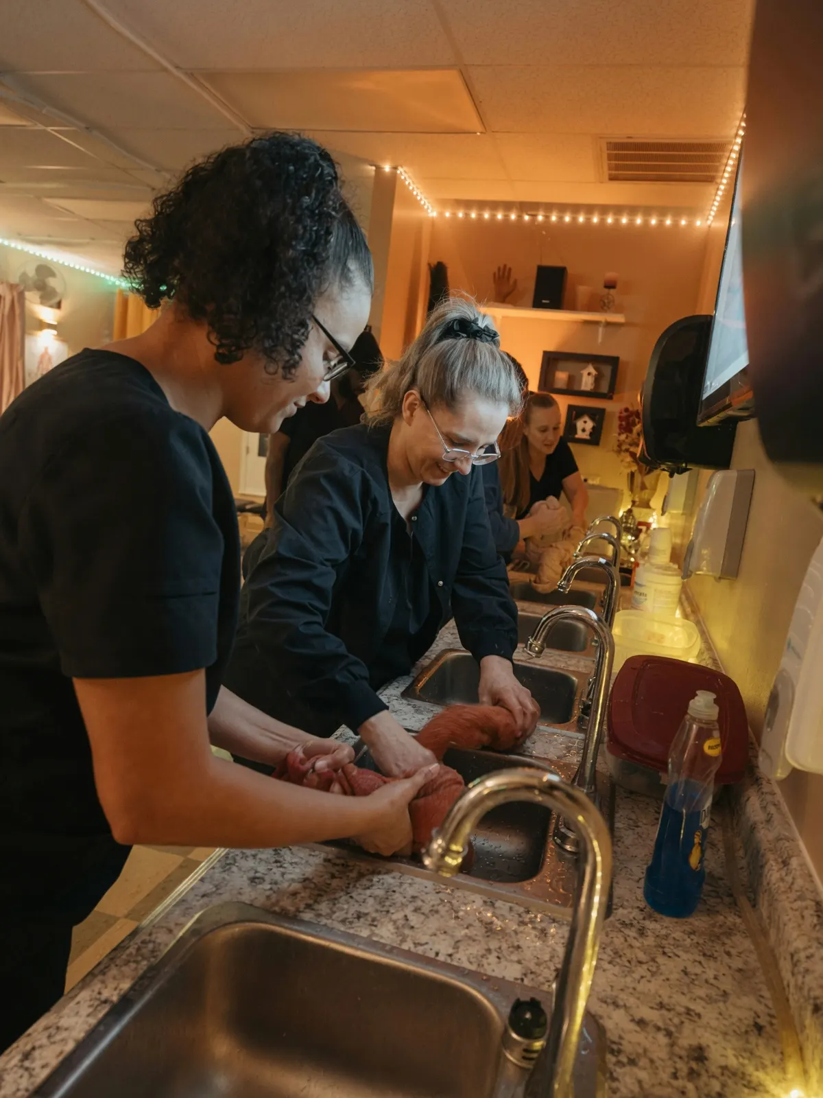Students washing massage linens at row of sinks — Texas Massage Academy, Brownwood TX