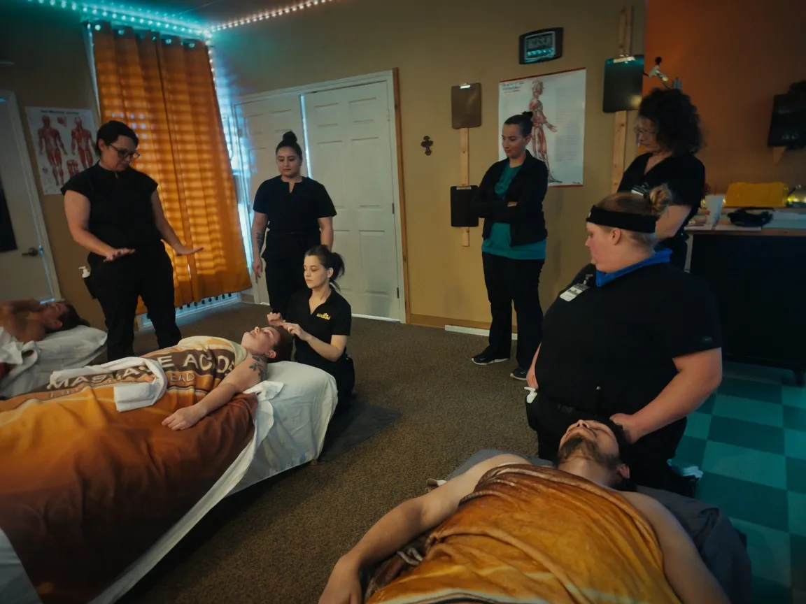 A full massage therapy class in session with students and instructors at the Texas Massage Academy Brownwood campus